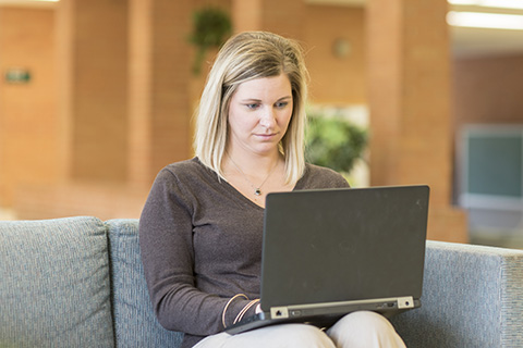 Abby working on a laptop.