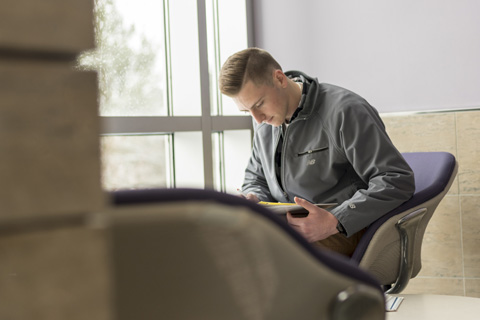 Anthony working in a student lobby.