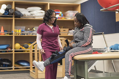 Casaundra working with another student in the PTA lab.